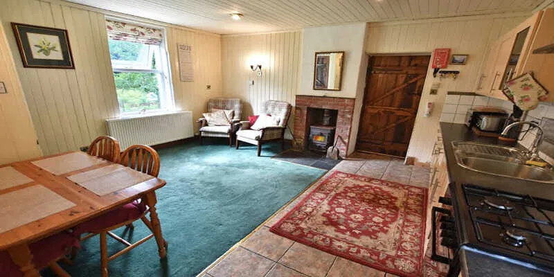 A cozy living room with a stone fireplace.