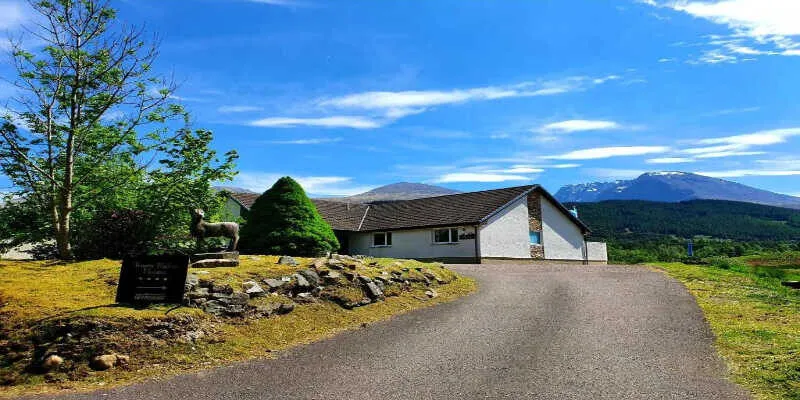 An elegant stone lodge overlooking a misty valley